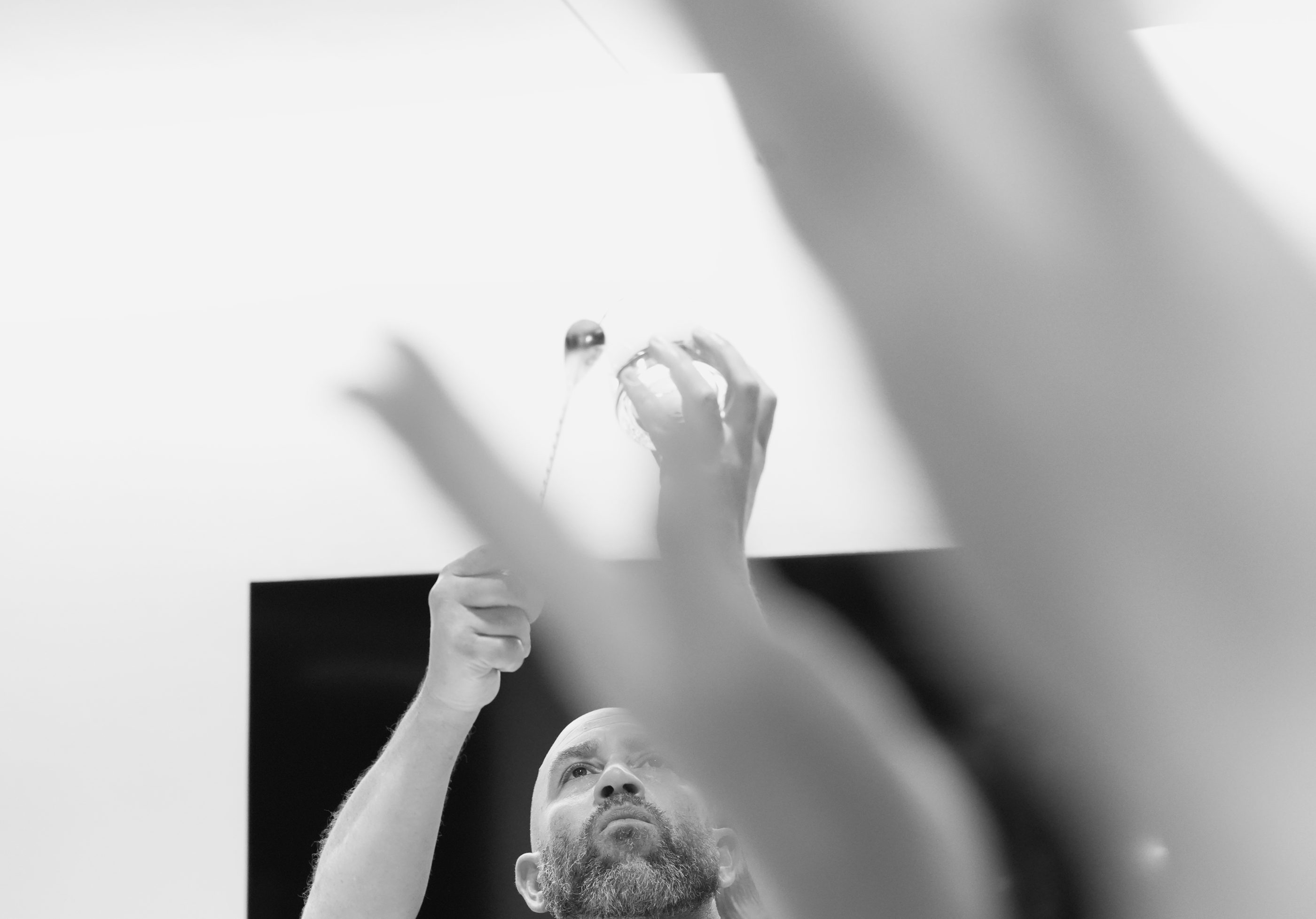 Black-and-white photo of hands holding up a print.